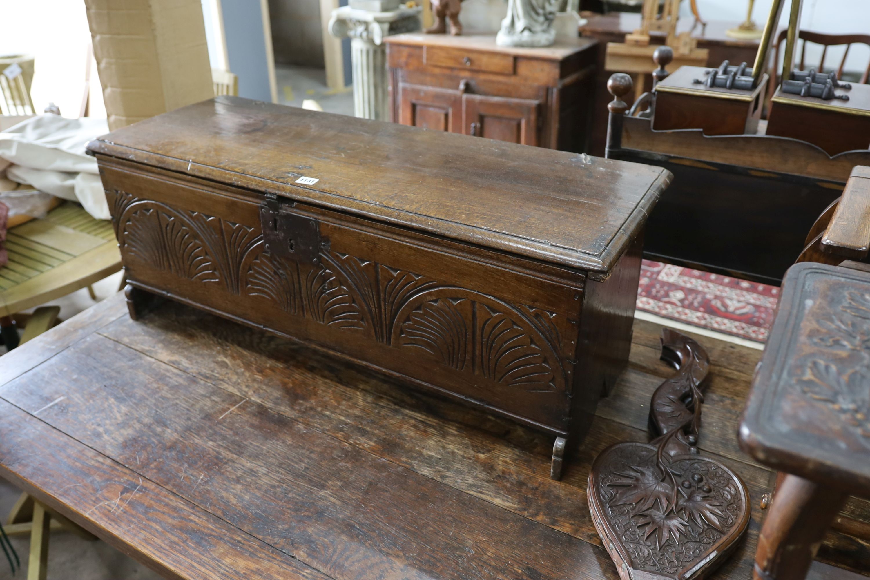 A 17th century carved oak six plank coffer, W 99, D 36, H 38cms.